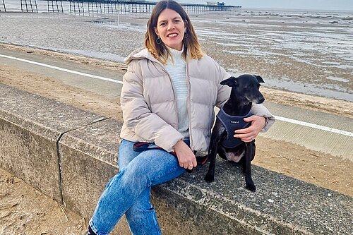 Image of Erin Harvey and dog at Southport beach.