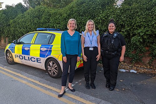 Lisa Smart with GMP and mental health nurse in front of police car